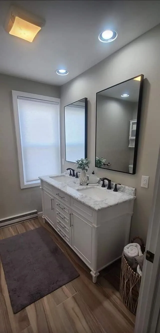 Bathroom remodeling project featuring double vanity and modern lighting.